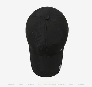 Detail view of black baseball cap with diamond quilting and metallic sport accent