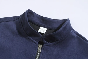 Detail of dark blue stand collar with silver metal zipper and soft suede texture