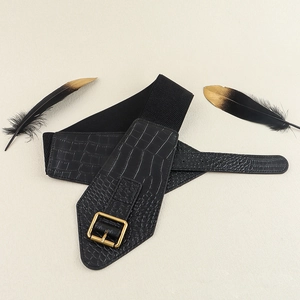 Detail of black wide belt for women with crocodile texture and gold square buckle