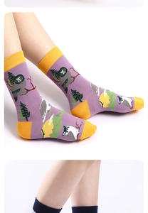 Detailed view of purple owl pattern cotton crew socks with contrasting yellow toe and cuff