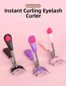 Detail of portable stainless steel eyelash curlers in black, purple and pink with heart grips