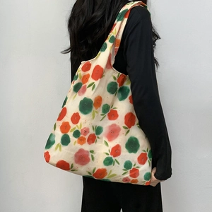 Detail of floral canvas tote bag showing large capacity and artistic watercolor print