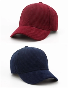 Detailed view of the striped corduroy fabric texture on wine red and navy baseball caps