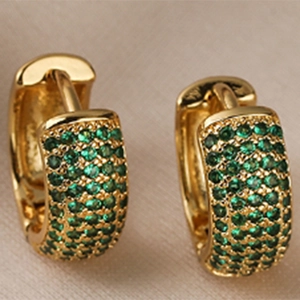 Elegant gold-plated C-shaped hoop earrings with sparkling green zircon inlays