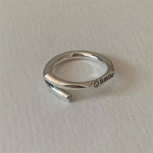Minimalist S925 sterling silver open ring featuring smile face engraving on leather background