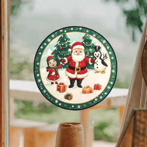 Christmas window stickers featuring Santa, penguin and tree decorations on glass surface