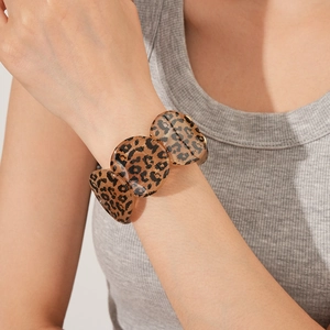 Close-up of leopard print acrylic bracelet with vintage resin round splicing links