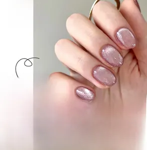 Short round cat-eye press-on nails in shimmering pink purple finish with detail view