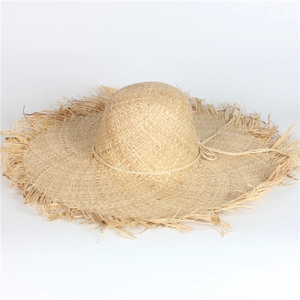 Wide brim raffia sun hat for women with raw frayed edges and adjustable chin cord