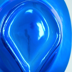 Close-up of electric blue plastic top hat with metallic finish and pearlescent texture
