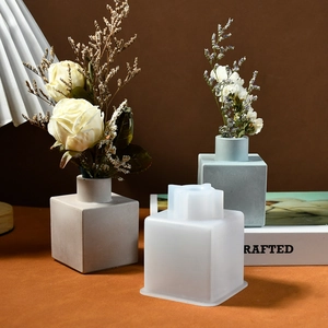 Detail of square silicone vase mold shown with finished cement flower vases for home decor