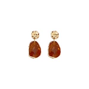 Vintage irregular gold hammer finish earrings with amber resin drops on white background