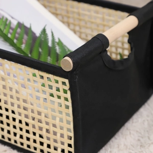 Foldable woven storage basket with wooden handles and black fabric sides for home decor