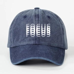 Washed navy blue denim baseball cap featuring white FOCUS lettering on a minimalist style