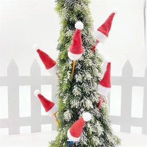 Mini red and white non-woven Christmas lollipop hats decorating a snowy Christmas tree