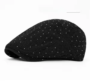 Detail of black newsboy cap with silver rhinestones and textured fabric finish