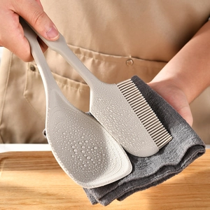 Beige non-slip silicone 2-in-1 heat-resistant spatula and scraper set on wood