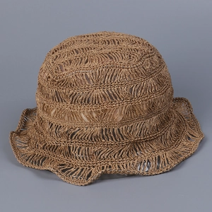 Close-up showing the intricate hollow hand-woven straw texture of this summer bucket hat