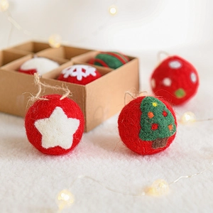 Handmade wool felt Christmas tree ornaments set with snowflakes and stars in festive gift box