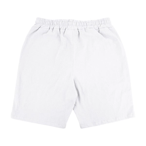 Detail of white linen shorts featuring a flexible elastic waistband and breathable fabric