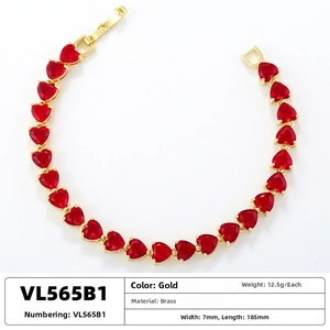 Detailed view of a gold heart bracelet measuring 7mm wide and 185mm long with red stones