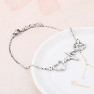 Detail showing the adjustable lobster clasp and extension chain of this steel heart bracelet