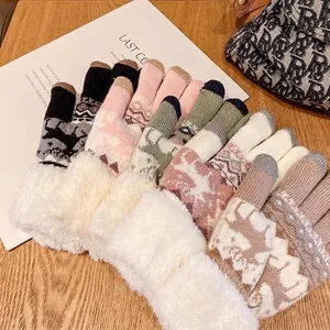 Warm winter touchscreen knit gloves with plush fur cuffs in multiple colors on wood table