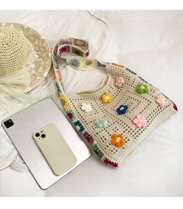 Detailed size comparison of the floral crochet tote bag with a phone and iPad