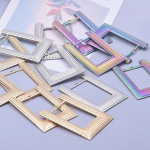 Textured square earrings in gold, silver, and rainbow steel shown from a top-down view