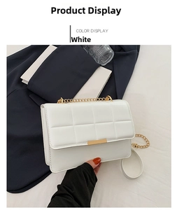 Detail of white quilted leather flap bag with gold chain strap and metal clasp closure