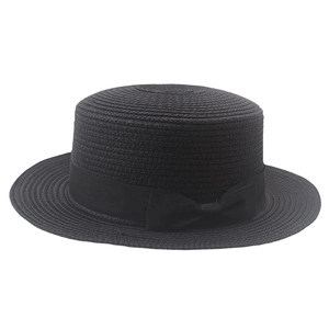 Detail of a black woven boater hat featuring a stylish grosgrain ribbon and bow detail
