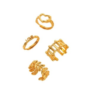 Set of four gold-plated stainless steel rings featuring love heart and leaf designs