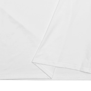 Detailed macro view of white fabric texture and precision stitching on the dress hemline