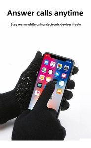 Close-up of black touchscreen winter gloves with anti-slip silicone grip on a smartphone