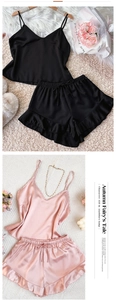 Detailed view of silk pajama sets in black and pink with ruffled shorts and lace-up design