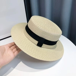 Classic French style boater straw hat with black contrast ribbon for seaside vacation