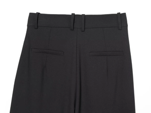 Detailed back view of men's black suit pants showing waist loops and welt pockets