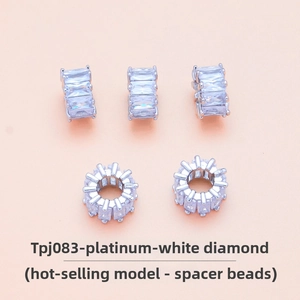 Macro shot of silver-colored spacer beads featuring micro-pave white zirconia crystals