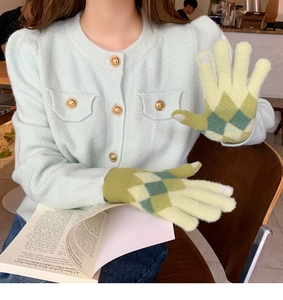 Detail of checkered knit gloves with touchscreen fingertips and textured wool blend fabric