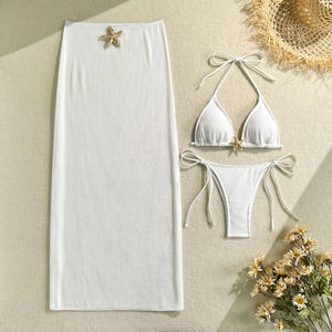 Detailed close-up of white honeycomb bikini with golden starfish hardware and mesh skirt