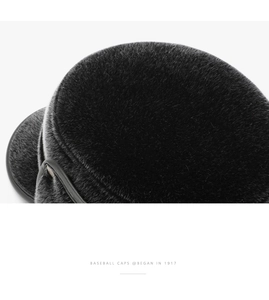 Macro shot of black plush faux fur material and premium texture detail on warm winter cap