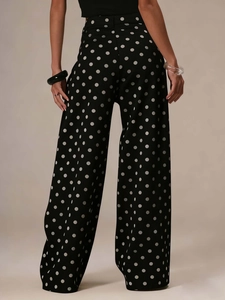 Detailed back view of vintage-style black polka dot wide leg jeans showing drape and fit