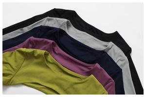 Flat lay of multiple athletic shawls in various colors showing smooth knit texture