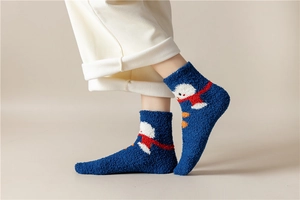 Detail of blue coral fleece Christmas sock featuring a white snowman pattern on feet