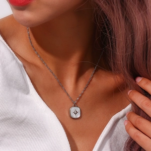 Silver twisted rope chain with a square white shell pendant featuring a starburst detail