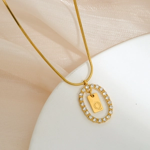 Detailed view of gold plated oval pendant with micro-inlaid zircon and letter Q design