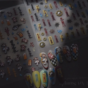 Macro detail of Chinese Taoist nail art stickers with embossed charms and patterns