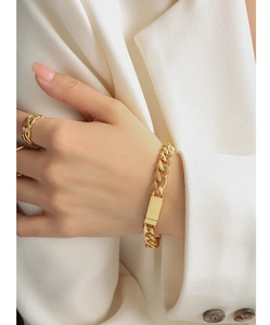 Polished 18K gold Cuban link bracelet with rectangle ID plate and rope textured ring