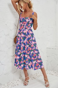Detailed close-up of blue floral midi dress featuring pink flower prints and waistline cut