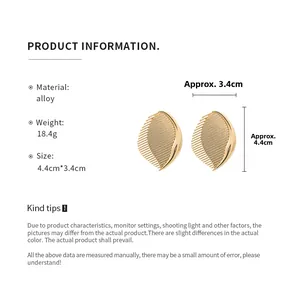 Detail view of gold-plated leaf earrings with alloy specs, weight 18.4g and size 4.4cm x 3.4cm